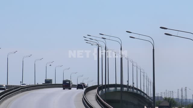 Cars driving on a country road.
Bridge, cars, road, lights, clear weather. The movement of cars,...