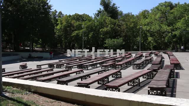 Relaxation area in the Park in the summer.
Benches for spectators in front of the outdoor...