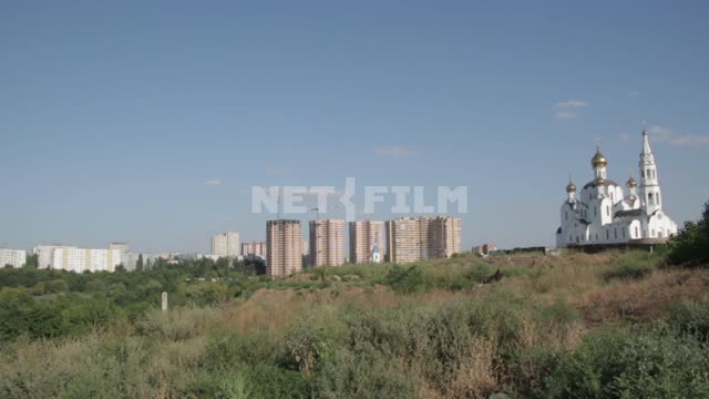 The outskirts of the city.
Flats, houses, temple, Church. dome, vacant lot, grass, summer, sky,...
