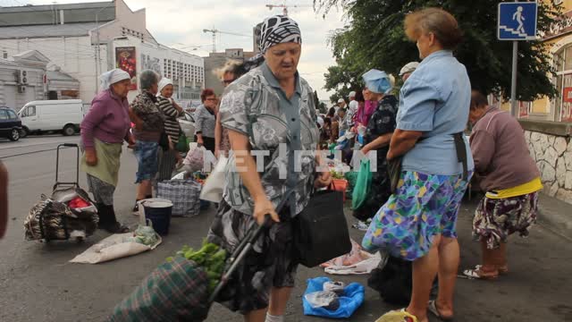 Grandmother sell vegetables with it.
Trade stalls, a farmers market, buyers, sellers, greens,...