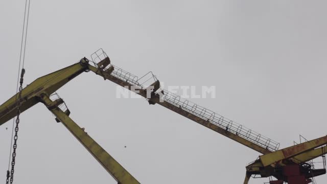 Birds fly in the background of a construction crane. crane, birds, flock, sky crane, birds, flock,...