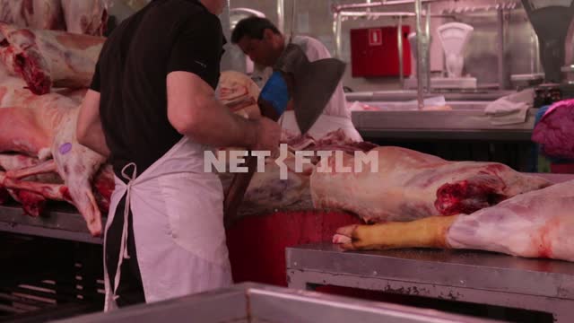 Butcher chopping meat. market, Russia, meat, carcasses, axe, butcher, hoof, scale, apron, meat...