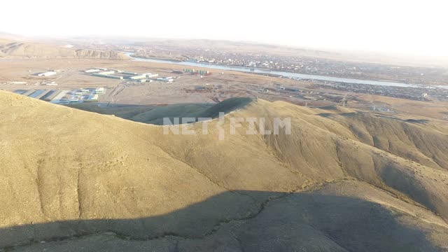 Аэросъемка, вид тувинских гор сверху, с высоты птичьего полета. Вдалеке виден город Кызыл и...