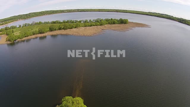 Aerial photography, a bird's eye view on gadflies of the lake, the banks covered with greenery and...