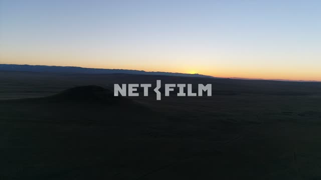 Aerial photography: shooting with a copter, dark mountains, the pink sunset, mysterious mountain,...
