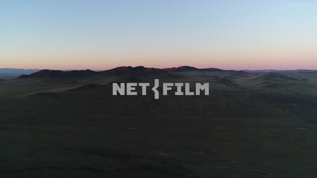 Aerial photography: shooting with a copter, dark mountains, the pink sunset Aerial photography,...