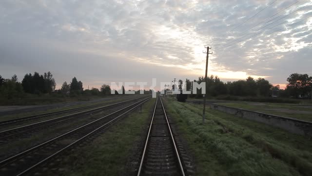 Railway rails leaving afar, the view from the last car, roadside station Railway rails leaving...