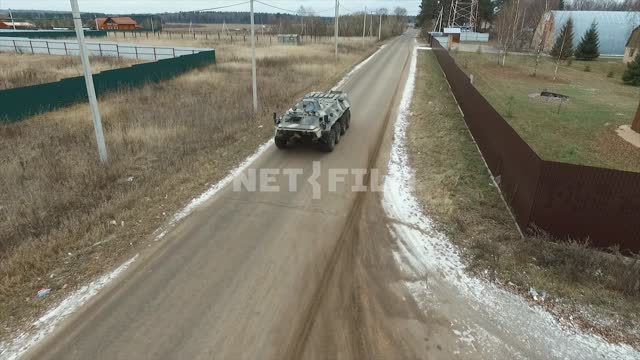 Aerial photo, survey copter.
Military armored vehicle driving on a road past various military...