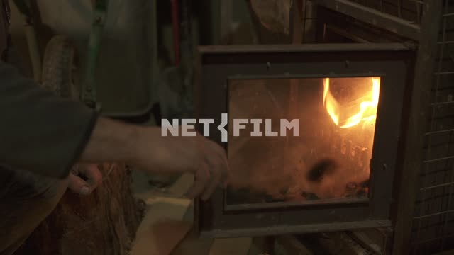 Man tries to close the oven door.
Oven, fire, glass, firewood, flame, firewood, logs, sparks,...