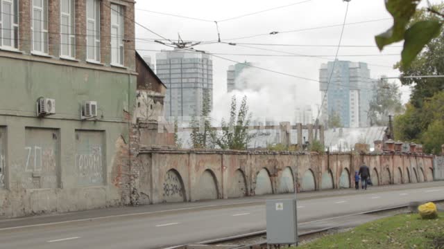 Smoke rises due to an old fence, go past a man with a child, a passing police car.
City, Russia,...