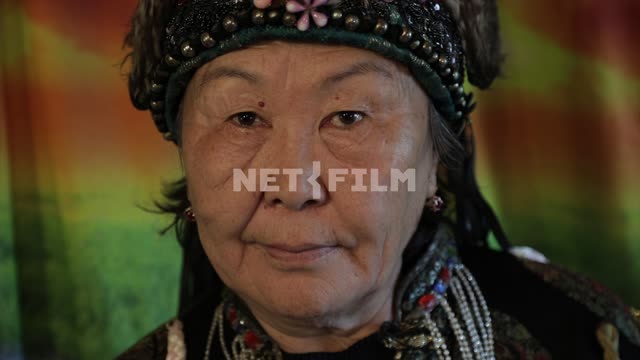 An elderly shaman looking at camera, portrait of an elderly woman An elderly shaman looking at...