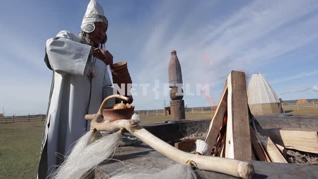 Yakut priest conducts the ceremony in a sacred place, the High sky, clouds, nature, ritual,...
