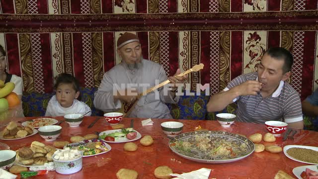 Many Kazakh family sitting at the table in the tent,
National color
National Kazakh cuisine, Yurt,...