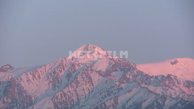 Pink snow-capped mountains. Pink snow-capped mountains.
Sky, mountains, dawn, nature