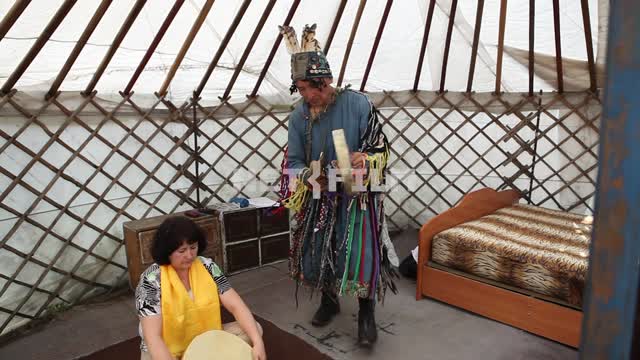 The shaman in a Yurt holds a ritual rite of passage, Shamanism, rituals, customs, Tuva The shaman...