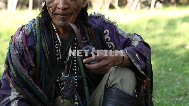 Colorful shaman was lighting his pipe, Colorful shaman lighting his pipe.
Ethnography shamanism,...