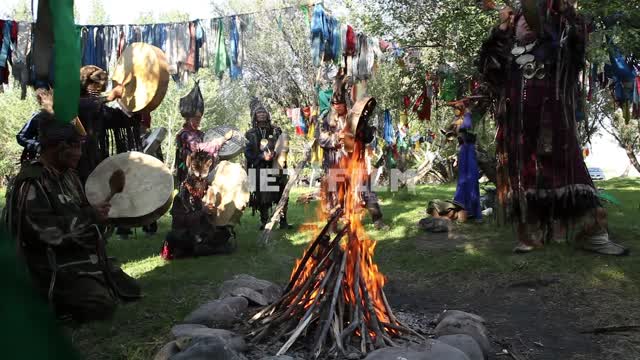 A shamanic ritual in a forest clearing, fire, jewelry, charms,
Shamanism, faith, religion,...