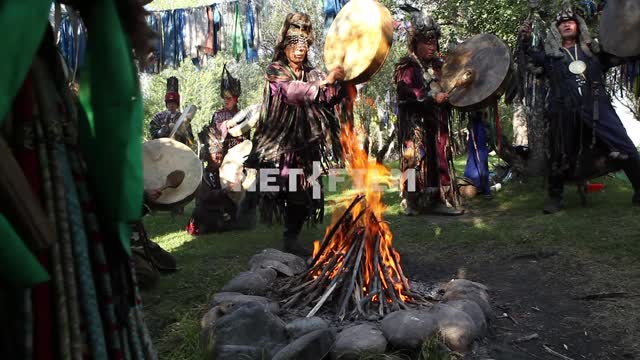 A shamanic ritual in a forest clearing, fire, jewelry, charms.
Shamanism, faith, religion,...