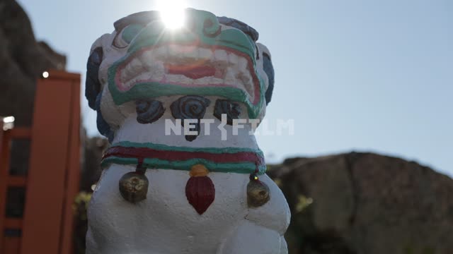 Figure of Buddhist deity at the entrance to mountain temple Figure of Buddhist deity at the...