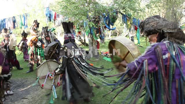 A shamanic ritual in a forest clearing, fire, jewelry, charms.
Shamanism, faith, religion,...