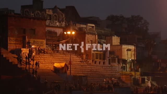 Stairs of a temple in Varanasi, shooting from boats Varanasi, temple, night, lights, people, stairs
