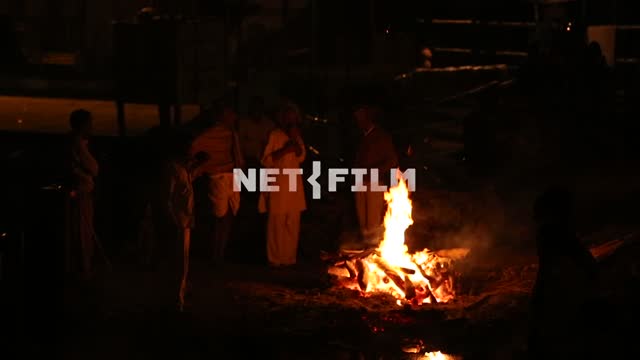a night of Indian men standing around the campfire fire, fire, Indian men, exoticism, Ethnography
