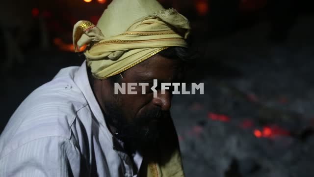 the pensive face of the Indian sorcerer on night fires Indian sorcerer, face, fire, flame, night,...