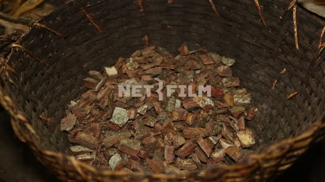 shopping cart which is dried pieces of Indian medicinal plants, a hand is a handful of the mixture...
