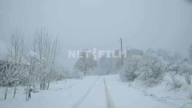 The view from the cockpit.
The car enters the deserted snow-covered village.
Russia.
Winter, car,...