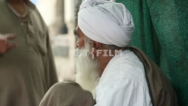 Colorful Santa in a turban, sitting and talking with the person next to Grandfather, turban, local...