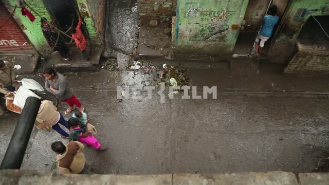 Dirty street in the slums, where people go and the Bicycle rides Street, people, slum, view from...