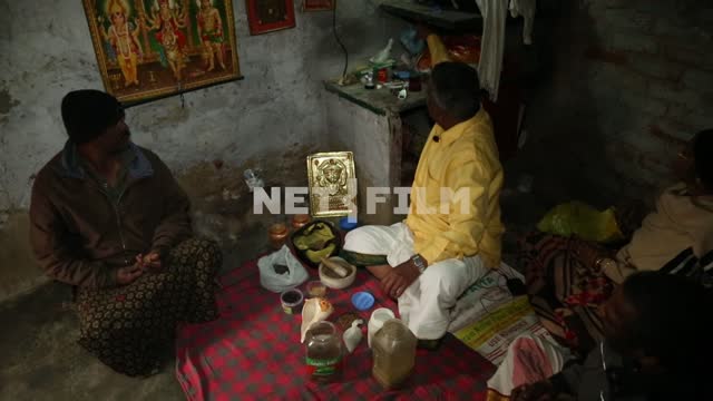 Indian healer receives visitors in his office in the slums. Healer, herbalist, India, slums,...