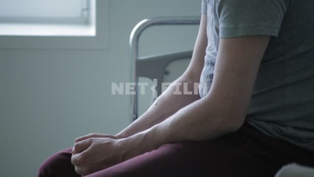 A man sits in a hospital bed. close-up, hands.
Hands, torso, male, hospital, bed, bed, t-shirt...