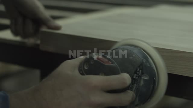 A carpenter polishes a wooden Board Polishing machine, polishing, carpenter, an artisan wooden...