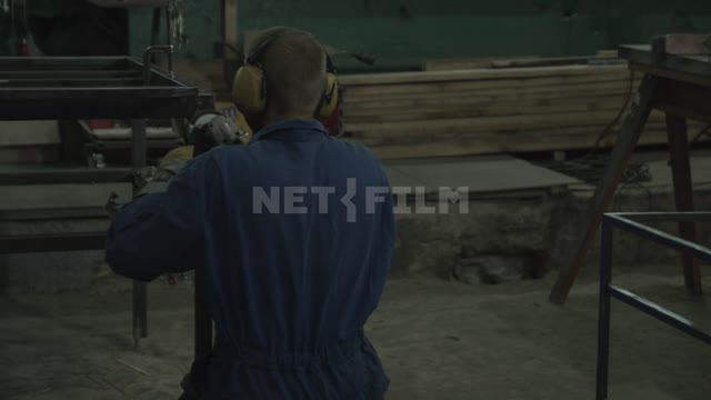 A welder at work Welder, helmet, protective suit, gloves, workwear, sparks, metal, welding, welding...