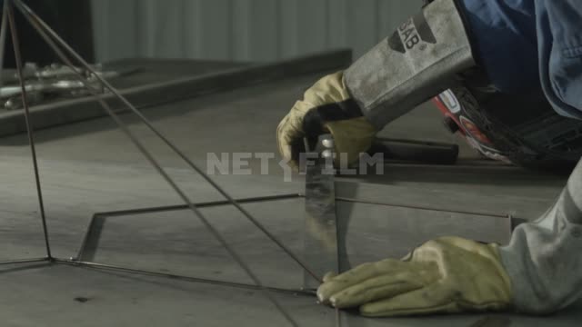 The welder assembles the metal frame of the lamp.
Master, welder, welding, angle grinder, angle...
