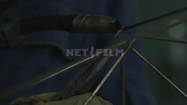 Close-up, the person welds the design of the metal spokes.
Design, pyramid, model, concept, metal,...