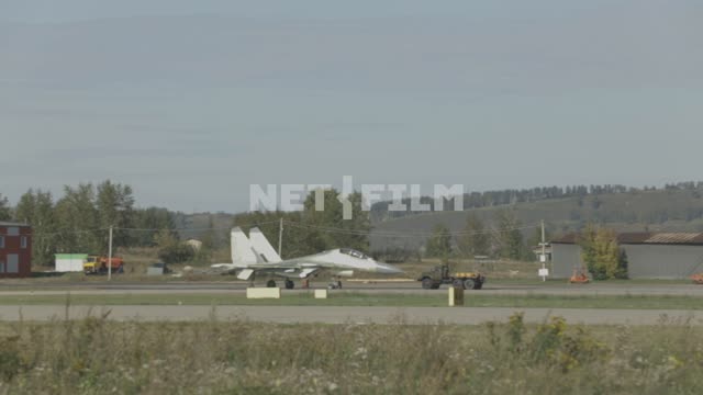 The truck tows a MOMENT on the airfield.
Russia, fighter, MIG, truck, airfield, runway, airfield,...