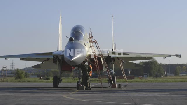 A pilot and a mechanic checks the condition of the fighter.
Russia, airfield, military airfield,...