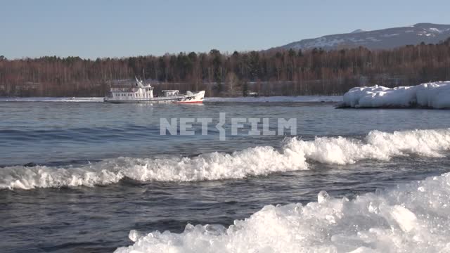 Lake Baikal, the waves are rushing on the shore, a ship is sailing to the shore Baikal, lake,...