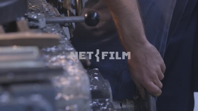 Close-up, the worker controls the operation of the lathe and verify part accuracy.
Aircraft,...