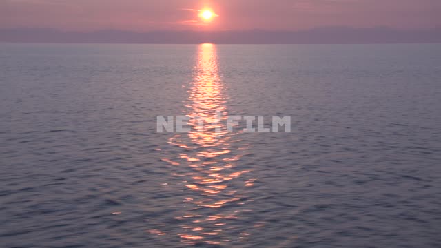Summer sunset on the lake, view from moving boat Russia, Siberia, lake Baikal, wildlife, nature,...