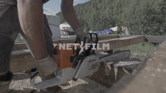 Close-up.
Builder sawing lumber with a chainsaw.
Construction, Builder, timber, tree, wood, notch,...