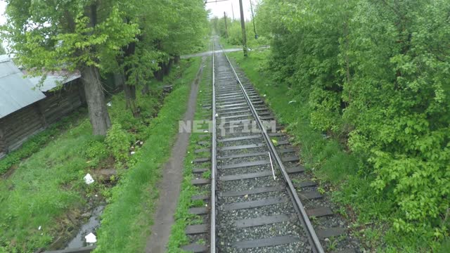The camera moves over an empty rails behind residential backyards.
Russia, Yekaterinburg, city, -...