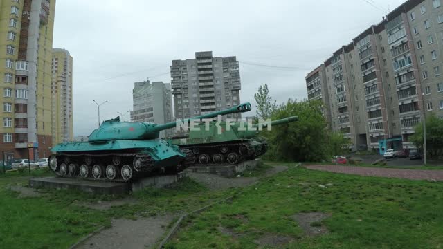 The camera runs through the deserted courtyard, on the monument of the tanks into a residential...