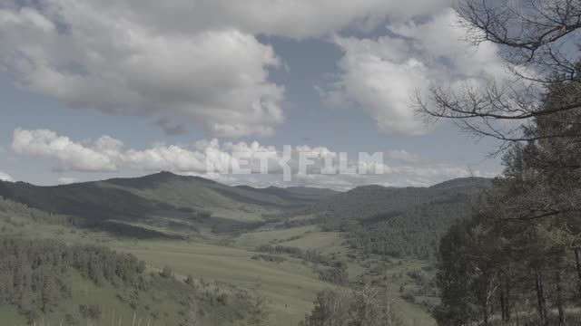 Plyvut clouds over a mountain valley.
Mountains, foothills, hills, forested mountains, forest,...