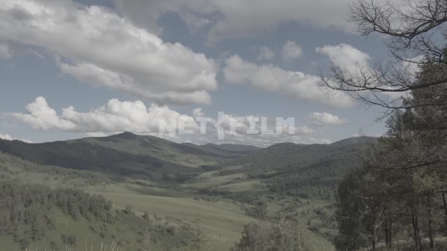 Clouds float above the mountain valley.
Mountains, foothills, hills, forested mountains, forest,...