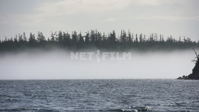 View from the boat to the island on the lake, thick fog Russia, Siberia, Baikal, Buryatia, nature,...