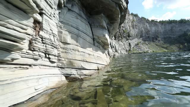 Nature of the Urals, rocky river bank, shooting on the water with movement along the wall Gafuri...