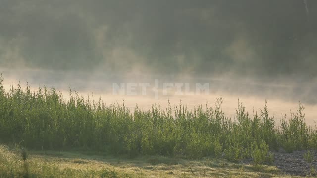 Morning fog, a man passes along the shore Ural, Salavatsky district, morning, dawn, sunrise, fog,...